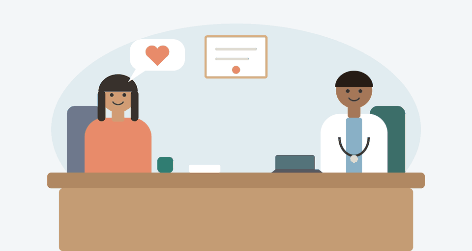 A doctor listening to a patient across a desk