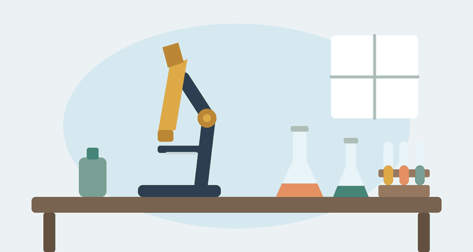A microscope, flasks and test tubes on an early laboratory bench